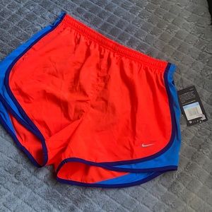 Bright Nike running shorts. Never worn. Size M